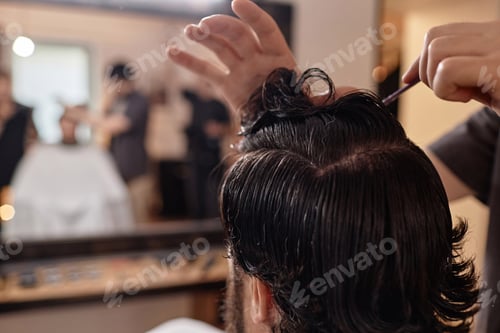 Preview: Barber combing hair of customer