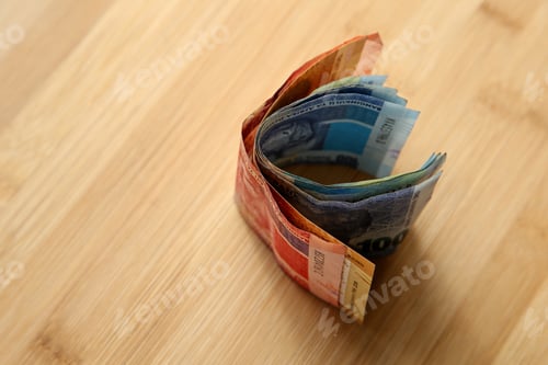 Preview: High angle closeup shot of a some cash on wooden surface