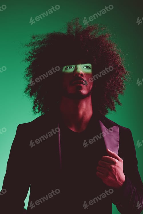 Preview: Portrait of a stylish man in a jacket on a green background multinational, color light, trend