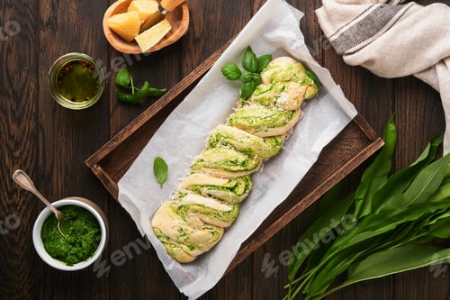Preview: Braided wild garlic pesto brioche. Homemade raw or uncooked fresh pull apart bread with wild garlic