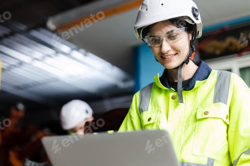 Preview: female technician engineer using laptop checking automation robotics