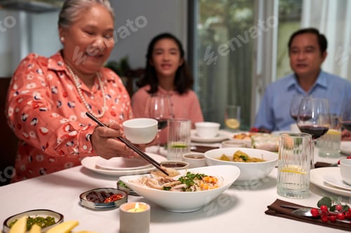 Preview: Grandmother Eating Food at Dinner