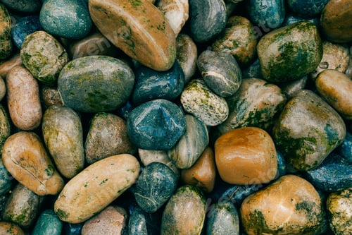 Preview: Colorful smooth stones on the shore. Backgroung with rocks
