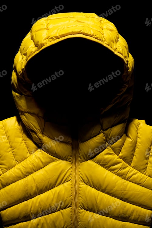 Preview: Vertical shot of a yellow down jacket on black background