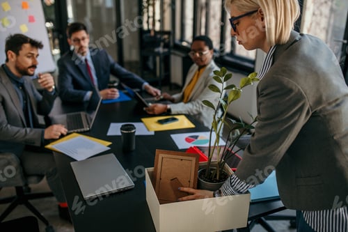 Preview: Businesswoman packing personal belongings leaving office after job loss or resignation