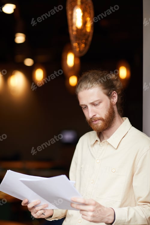 Preview: Young man examining the documents