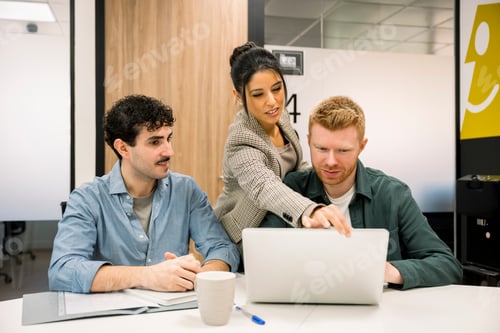 Preview: Colleagues collaborating on new project in modern office