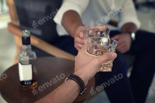 Preview: Young men drinking whiskey together at home, closeup