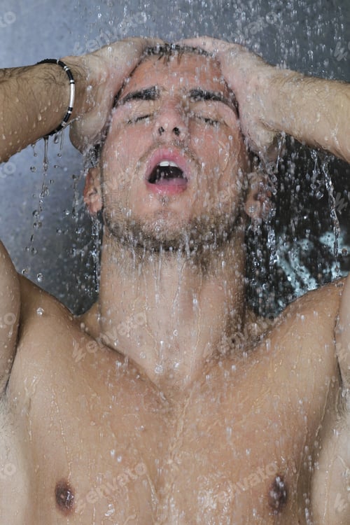 Preview: Young Good Looking And Attractive Man With Muscular Body Wet Taking Showe In Bath With Black Tiles