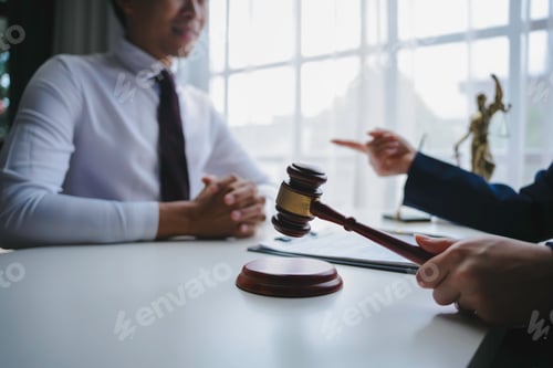 Preview: Lawyer explains a contract to a client in a cozy office