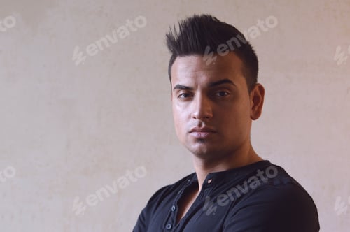 Preview: dark moody portrait of cool young turkish man with spiky hair