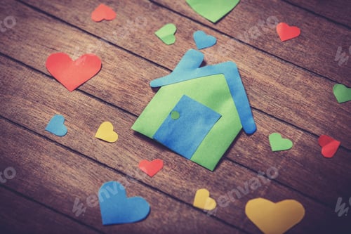 Preview: Paper house on wooden table.
