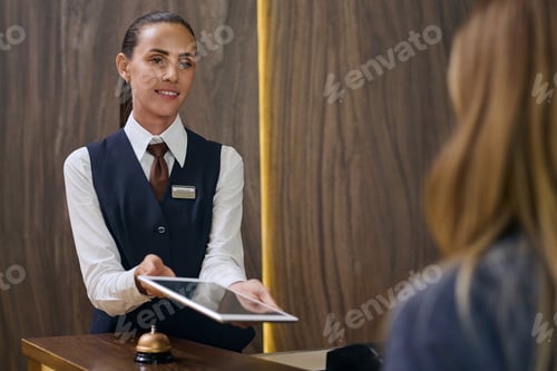 Preview: Manager registrating guest in the hotel