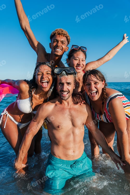 Preview: Vertical portrait of a group of multiracial friends having fun swimming on the beach. Young adult