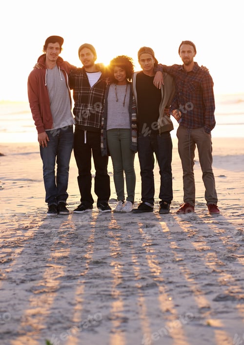 Preview: Show us what you got. Shot of a group of friends on a beach at sunset.