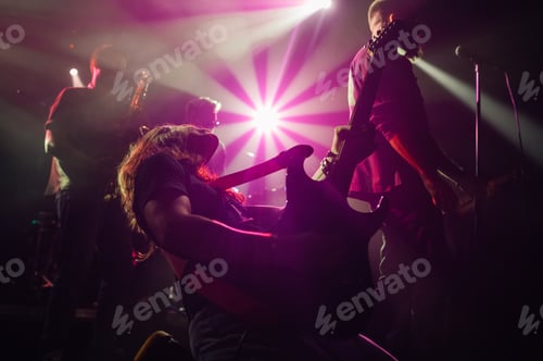 Preview: Guitarist performing with passion on stage during live concert