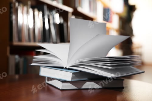 Preview: Stack of books on table in library