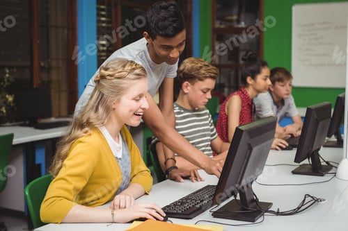 Preview: Smiling students studying in computer classroom