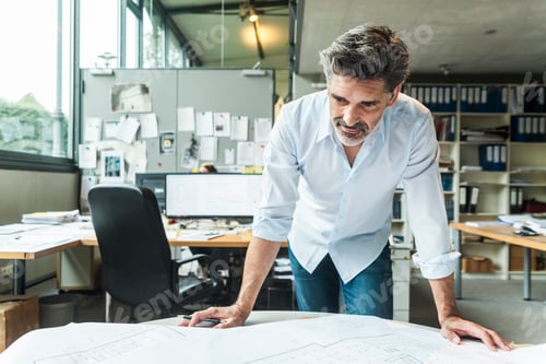 Preview: Architect working on ground plan in office