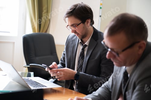 Preview: Group of business people sitting around the office desk and discussing the project together