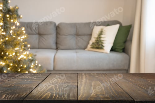 Preview: Blurred home interior in living room, decorated Christmas tree, wooden tabletop.
