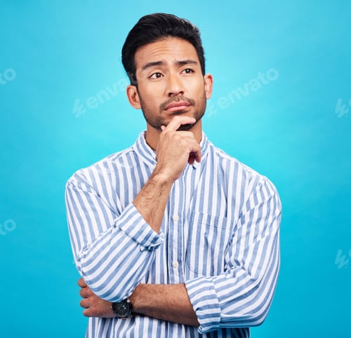 Preview: Thinking, planning and future with a man on a blue background in studio to consider a thought or op