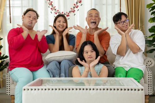 Preview: A family of autistic children are having fun playing board games together by the Christmas tree.