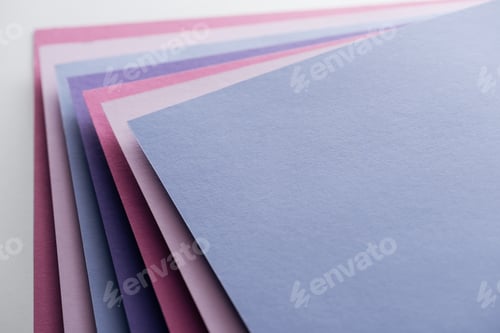 Preview: empty blue, white, pink and purple sheets of paper on white background