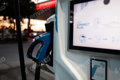 Preview: electric vehicle EV charging station night dusk blue charger cable handle display screen