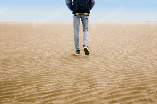 Preview: Person Walking on Vast Sandy Beach Alone