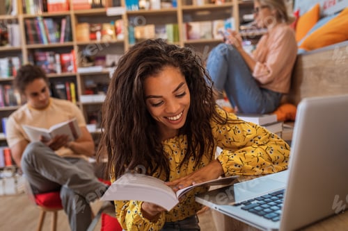 Preview: Portrait of young African American female student study in the library.