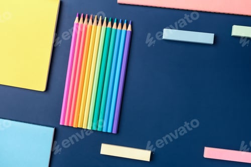 Preview: top view pastel notebook with pencil and stationery on navy blue table background