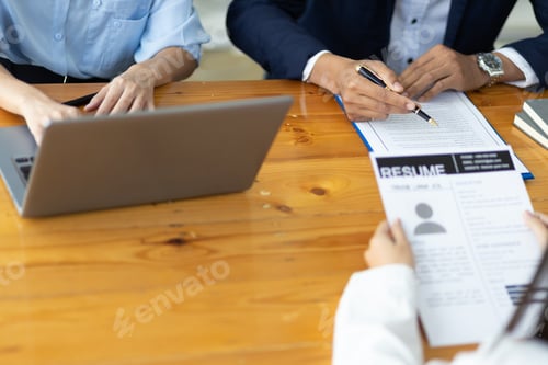 Preview: The employer or committee is interviewing and discussing the job applicant's resume.
