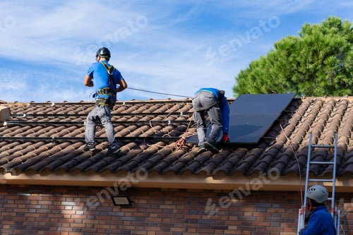 Preview: Workers installing solar panel on a roof of residential building