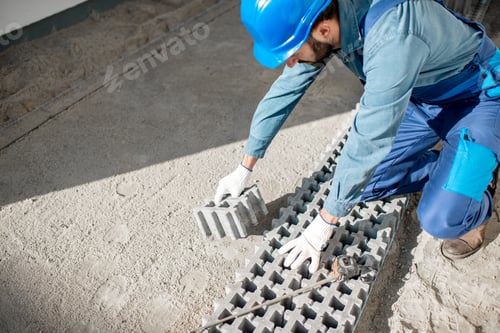 Preview: Builder laying paving tiles