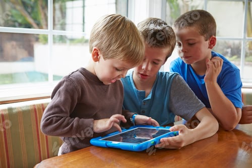 Preview: Three boys playing with digital tablet