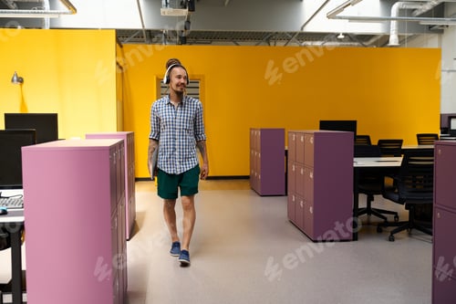 Preview: IT specialist with beard and mustache enters room with pink lockers