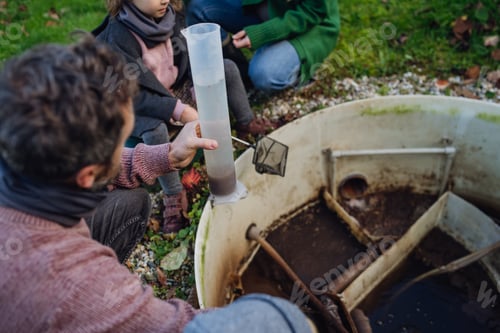Preview: The family checks the water quality in the home wastewater treatment system. Concept of sustainable