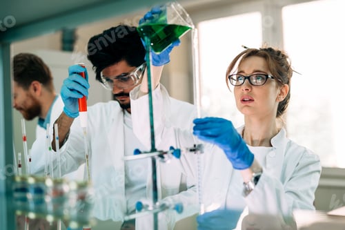 Preview: Young students of chemistry working in laboratory