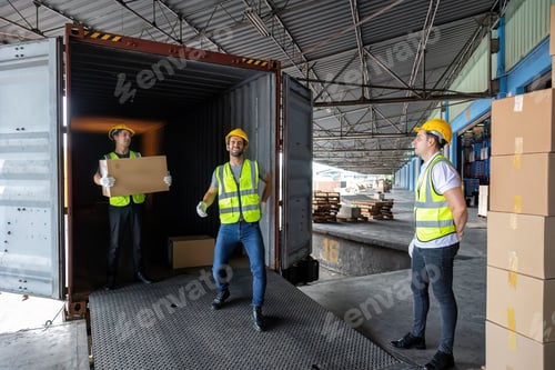 Preview: Worker carry carton box taken from 40 feet steel container on the trailer truck park at warehouse