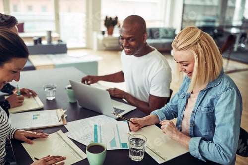 Preview: Smiling group of diverse businesspeople talking together during a meeting