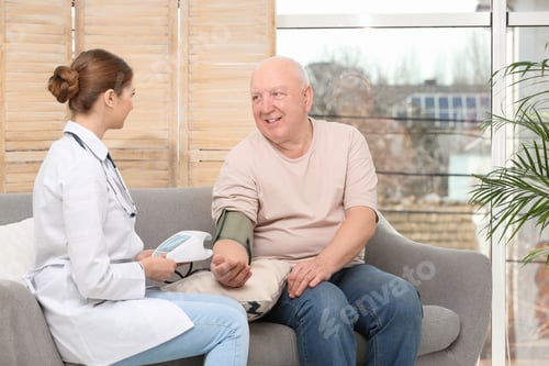 Preview: Health Professional Checking Senior Man Blood Pressure Indoors