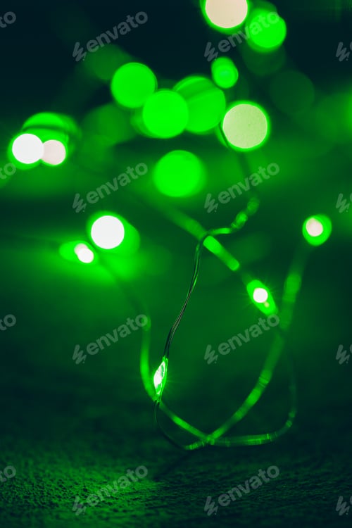 Preview: Bokeh of green garland lighting elements background