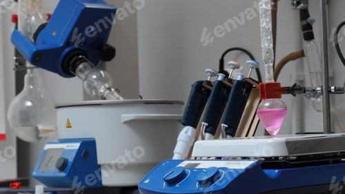 Preview: Equipment in chemical laboratory with rotating flasks. Stock footage. Rotating equipment and colored