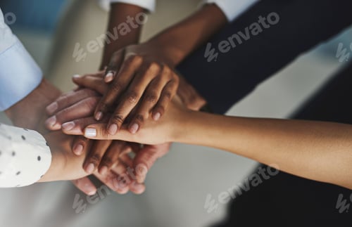 Preview: On three...High angle shot of a group of unrecognizable coworkers hands in a huddle.