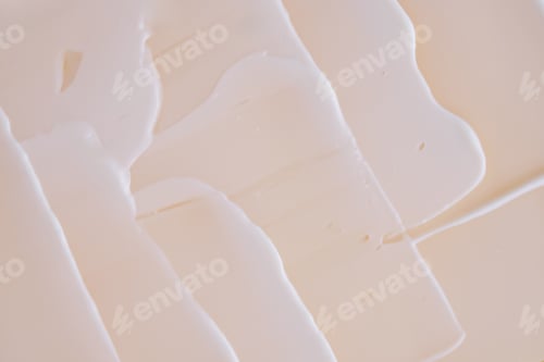 Preview: Swatch with white cream texture on a beige background.