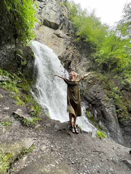 Preview: Woman Enjoying Nature near Waterfall