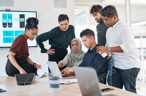 Preview: Shot of a group of businesspeople using a laptop during a meeting in a modern office