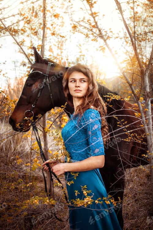 Preview: Beautiful girl in a blue dress looks into the distance