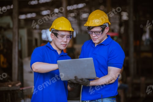 Preview: Engineer worker wearing safety uniform control operating computer controlled Lathe grinding machine